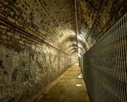 The Prison is a black basalt and red sandstone str The Prison is a black basalt and red sandstone structure built between the years 1843 and 1845. It was designed by Sir Charles Lanyon. There are guid
